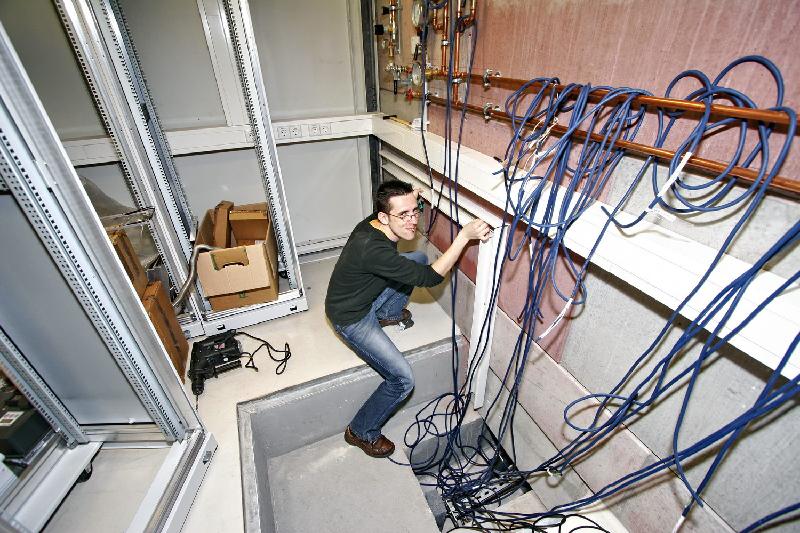 2008-04-02_03 Nicki mounting the cable channel for the magnet power supplies.